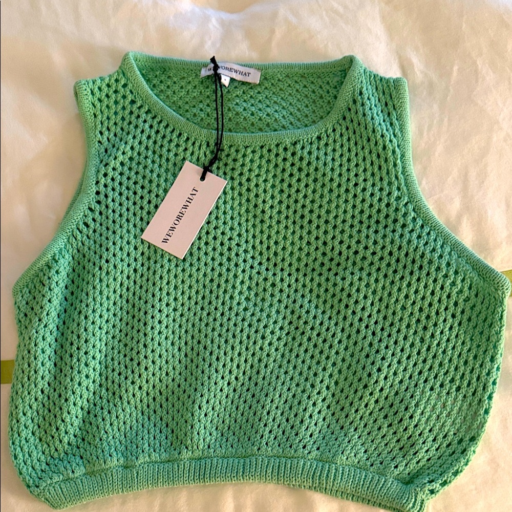 We wore what pale green crochet sleeveless sweater top size S 
NWT